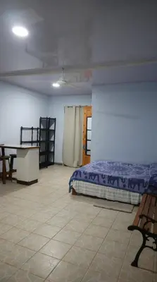 a room with a bed and a table in it at Blue Morpho House B&B in Manuel Antonio