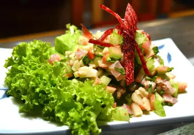 a salad on a white plate on a table at Hotel Columbus in San José