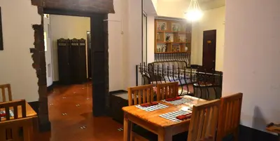 a dining room with a wooden table and chairs at Hotel Columbus in San José