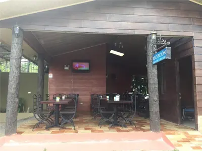 a restaurant with tables and chairs in a building at Hotel Vale's in Chiles