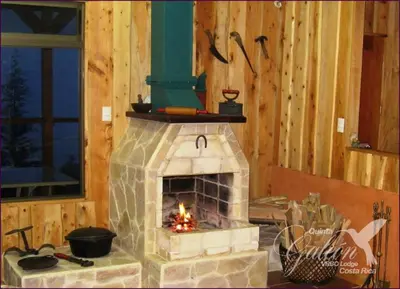 a brick oven in a room with a fire at Quinta Galeon Lodge in Santa María