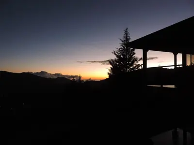 a sunset with a tree and a gazebo at Quinta Galeon Lodge in Santa María