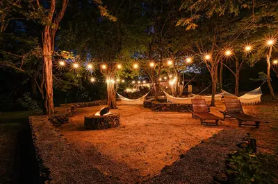 a park with hammocks and lights at night at Papagayo Golden Palms Beachfront Hotel in Papagayo, Guanacaste