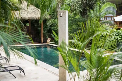 a swimming pool in the middle of a resort at Ohana Villas in Santa Teresa Beach