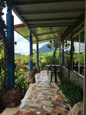 a patio with a table and a stone walkway at Talamanca Nature Reserve in Rivas