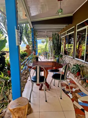 a patio with a table and chairs on a patio at Talamanca Nature Reserve in Rivas