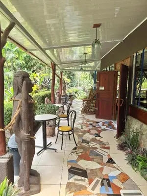 a patio with a tile floor and a table and chairs at Talamanca Nature Reserve in Rivas