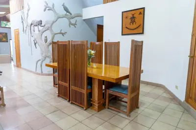 a dining room with a wooden table and chairs at Talamanca Nature Reserve in Rivas