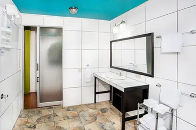 a bathroom with a sink and a mirror at Tico Tico Villas - Adult Only in Manuel Antonio