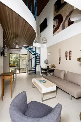 a living room with a couch and a table at Tico Tico Villas - Adult Only in Manuel Antonio
