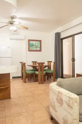 a living room with a couch and a table at Inn On The Park in Manuel Antonio