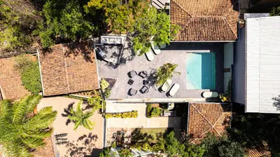 an overhead view of a house with a swimming pool at Hotel Casa Leona in Tamarindo
