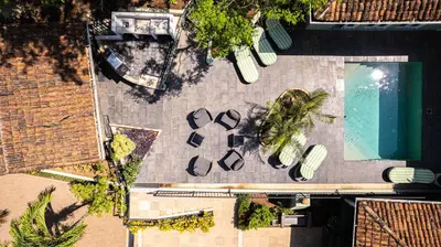 an overhead view of a swimming pool and a house at Hotel Casa Leona in Tamarindo