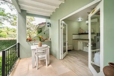 a balcony with a table and chairs and a kitchen at Hotel Casa Leona in Tamarindo