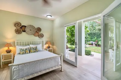 a bedroom with a bed and a sliding glass door at Hotel Casa Leona in Tamarindo