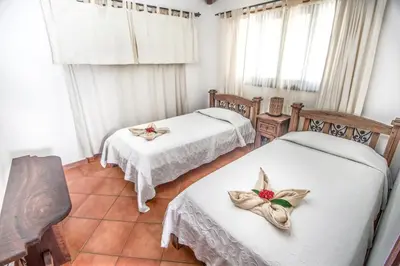 a room with two beds with flowers on them at Villas Kalimba in Sámara