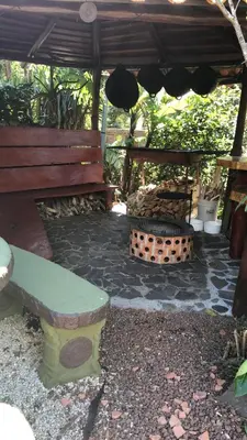 a patio with a bench and a fire pit at Casa Haydee Monteverde in Monteverde Costa Rica