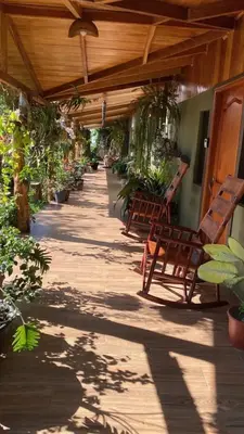 a patio with wooden benches and potted plants at Casa Haydee Monteverde in Monteverde Costa Rica