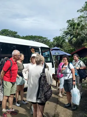 a group of people standing outside of a van at Hotel Pedacito de Cielo in Boca Tapada