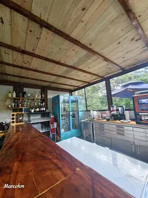 a large kitchen with a large wooden counter top at Hotel Pedacito de Cielo in Boca Tapada