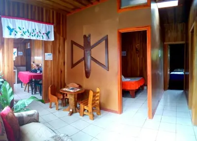 a room with a small table and a dining room at Pensión y Cabinas Colibrí B&B Costa Rica in Monteverde Costa Rica