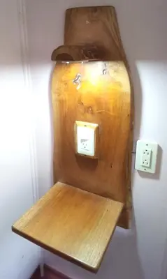 a wooden shelf attached to a wall with an outlet at Forest Garden House in Monteverde Costa Rica