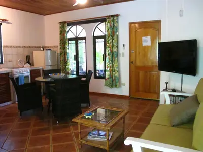 a living room with a couch and a table at Casa Amarilla in Esterillos
