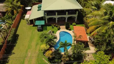 an aerial view of a house with a swimming pool at Casa Amarilla in Esterillos