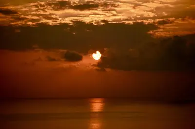 a sunset over the ocean with the sun in the clouds at Montezuma Heights in Montezuma
