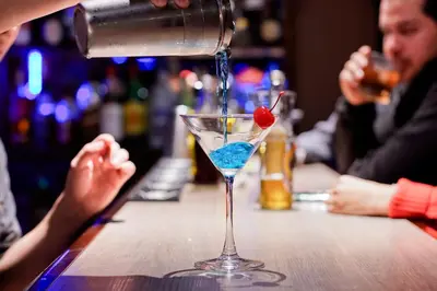 a drink is being poured into a martini glass at Savegre Hotel Natural Reserve & Spa in San Gerardo de Dota