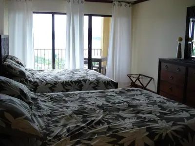 a bedroom with a bed and a window at Sunset Heights 402 in Playa Flamingo