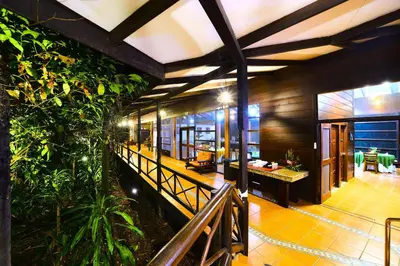 an indoor courtyard of a house with plants at Aninga Lodge in Tortuguero