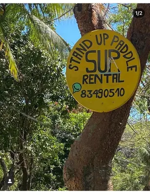 a yellow sign on a tree with a sun rental sign on it at Stunnig Ocean View in Montezuma