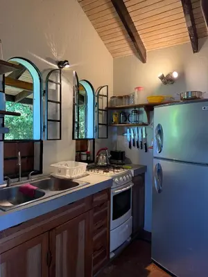 a kitchen with a white refrigerator and a sink at Stunnig Ocean View in Montezuma