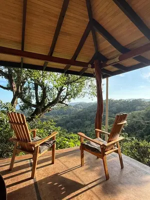 two chairs sitting on a porch with a view at Stunnig Ocean View in Montezuma