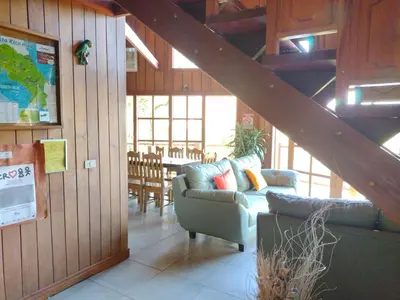 a living room with a couch and a table with chairs at Hotel Claro de Luna in Monteverde Costa Rica
