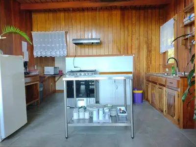 a kitchen with a refrigerator and a stove at Hotel Claro de Luna in Monteverde Costa Rica