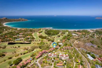 an aerial view of a resort near the ocean at Recently Renovated Luxury Condo with Resort-Style Beach Club Access and Ocean Views in Playa Conchal