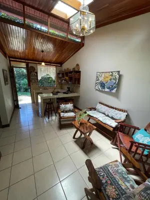 a living room with a couch and a table at Finca Isla Rainforest Retreat in Aguas Zarcas