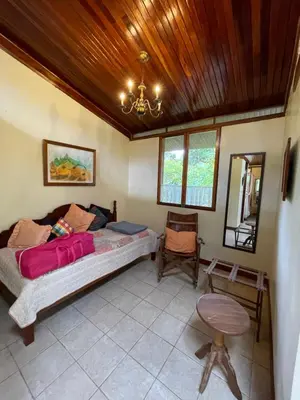 a bedroom with a large bed and a wooden ceiling at Finca Isla Rainforest Retreat in Aguas Zarcas