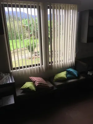 a window seat with pillows in front of a window at Posada Cañaveral in Ujarrás