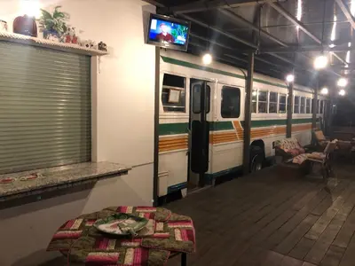 a bus parked in a garage with a table and a tv at Posada Cañaveral in Ujarrás