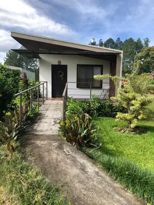 a small white house with a pathway leading to it at Posada Cañaveral in Ujarrás