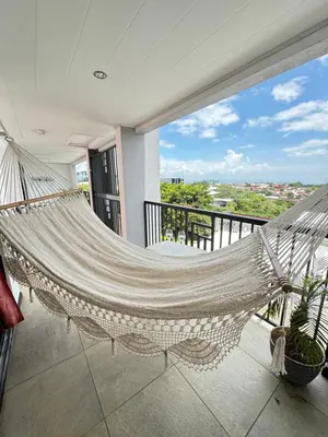 a hammock on the balcony of a house at Maria´s Apartments in Alajuela City