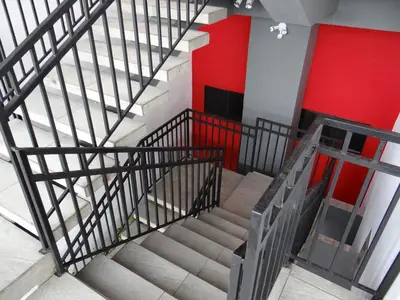 an overhead view of stairs in a building with a red wall at Maria´s Apartments in Alajuela City