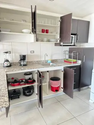 a kitchen with a sink and a counter top at Maria´s Apartments in Alajuela City