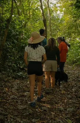 a group of people walking down a forest trail at Agutipaca Bungalows in Bagaces