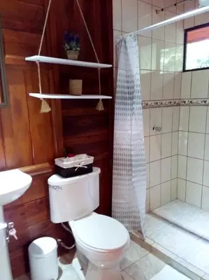 a bathroom with a toilet and a shower at Rancho de Lelo Ecolodge in Monteverde Costa Rica