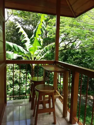 a porch with a table and two stools at Rancho de Lelo Ecolodge in Monteverde Costa Rica