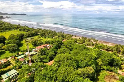 an aerial view of the beach and ocean at Hotel Tropical Sands Dominical in Dominical